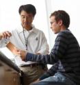 Ki Chon, left, professor and head of biomedical engineering at Worcester Polytechnic Institute, is in his lab with Ph.D. candidate Christopher Scully.