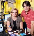 Georgia Tech professors Irina Sokolik and Athanasios Nenes hold samples of mineral dust they studied as part of research into the role played by insoluble dust particles in the formation of cloud droplets.