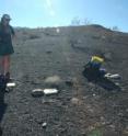 Geochemists dated the crater by analyzing rocks thrown out when it exploded. Lead author Peri Sasnett contemplates a sample.