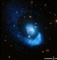Abell 2052 is a galaxy located in the constellation Serpens, about 480 million light years from Earth. This image was captured using X-rays from Chandra X-ray Observatory and optical data from the Very Large Telescope.