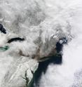 Nicknamed “snowmageddon,” an exceptionally severe winter storm dropped several feet of snow around the Washington, DC, area in early February 2010. Crashed and abandoned cars littered roads as airlines canceled hundreds of flights. Even the DC Metro train system stopped functioning in places.

The MODIS on NASA’s Terra satellite captured this true-color image on February 7, 2010, showing part of the region affected by heavy snowfall. Snow blankets the area hundreds of kilometers inland from the Atlantic coastline. Along the latitude of New York City, however, snow cover thins considerably.

Authorities urged residents to stay indoors, but hundreds of thousands lost electricity. The Washington Post reported that the snow-induced standstill might last until midweek, especially if a second winter storm arrived as predicted on Tuesday. As of Monday morning, government offices remained closed, and many streets remained unplowed.