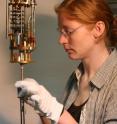 Researcher Heike Pfau attaches an experimental setup at the base of a cooling unit at the Max Planck Institute for Chemical Physics of Solids in Dresden, Germany. The experiment allowed Pfau and colleagues to measure thermal conductivity in a sample of ytterbium dirhodium disilicide -- one of the most-studied varieties of the exotic "heavy fermion metals."