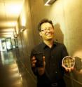 Nosang Myung holds the sensor that allows for the detection of harmful airborne substances.