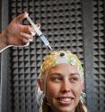 Sandia National Laboratories' Susan Stevens-Adams wears a cap dotted with electroencephalography (EEG) sensors that are injected with gel to make sure they have good contact. EEGs are used as part of a study into memory and memory training.