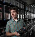 Sandia's David Fritz holds two Android smartphones, representing the virtual network of 300,000 such devices that he and other researchers are using to advance understanding of malicious computer networks on the Internet.