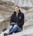 Researcher Darla Zelenitsky from the University of Calgary holds a skull of an ornithomimid preserved with feathers recovered from 75 million-year-old rocks in the badlands of Alberta, Canada.