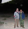 Botanists Wei Yi-Gang, Guangxi Institute of Botany, and Alex Monro, Royal Botanic Gardens Kew, standing within Yangzi cave with clumps of plants from the nettle family nearby.