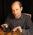 This image shows laser safety officer Joshua Hadler, NIST, and his apparatus for measuring the properties of handheld laser devices.