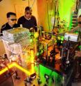 A team of Georgia Tech researchers adjusts equipment used to study a gaseous Bose-Einstein condensate composed of sodium atoms. The condensate could be used for communicating among quantum computers. Shown, (l-r) are postdoctoral fellow Carlo Samson, associate professor Chandra Raman and graduate student Anshuman Vinit.