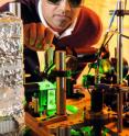 Georgia Tech associate professor Chandra Raman adjusts equipment used to study a gaseous Bose-Einstein condensate composed of sodium atoms. The condensate could be used for communicating among quantum computers.