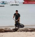 Zoological Society of London's Paddy Brock is shown with Galapagos sea lions.