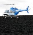 In June 2008, a little more than a year after the massive Anaktuvuk River fire on Alaska's North Slope, a helicopter used to ferry researchers from the University of Alaska Fairbanks, Institute of Arctic Biology, Toolik Field Station to the Anaktuvuk River fire burn site sits in stark contrast to the burned and seemingly lifeless tussock tundra.