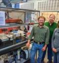 The research team, from left: Ron Zuckermann, Michael Connolly, and Gloria Olivier, standing next to their custom peptoid-making robot, RONDA.