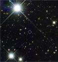 This composite image reveals the structure of Himiko, an object representing the merger of three young, bright galaxies as seen in the early Universe. The left panel shows the section of the sky containing Himiko (identified in box) and other distant galaxies, as imaged by Hubble's Wide Field Camera 3 (WFC3). CREDIT: NASA/Hubble. The image in the upper right is a close-up of Himiko with Hubble. The three infant galaxies are clearly resolved where only one was known to exist before. These objects are extremely energetic, suggesting they are undergoing a period of intense star formation. CREDIT: NASA/Hubble. The image in the lower right is the same object with additional data from the Spitzer Space Telescope and Subaru Telescope on Mauna Kea in Hawaii. The halo of ionized hydrogen gas is clearly seen surrounding Himiko. Observations with the Atacama Large Millimeter/submillimeter Array (ALMA) telescope did not detect any telltale signature from carbon, suggesting that these three objects may be very primitive and have not had enough time to seed the intergalactic medium with heavy elements.
