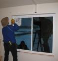 This image shows the installation of triple-pane windows in one of the Lab Homes on the campus of Pacific Northwest National Laboratory.