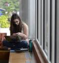 A Kent State University student texts a friend while studying on campus.