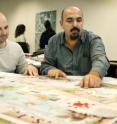 Taner &#214;zdil, an associate professor of landscape architecture and associate director for the Center for Metropolitan Density, reviews case studies with Dylan Stewart (left) and Sameepa Modi. Both Stewart and Modi are master's students in landscape architecture.