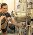 Brian LeRoy (right) and graduate student and first author of the study, Matthew Yankowitz, use a tunneling electron microscope to probe the electronic properties of graphene.