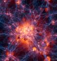 This still frame from the Illustris simulation is centered on the most massive galaxy cluster existing today. The blue-purple filaments show the location of dark matter, which attracts normal matter gravitationally and helps galaxies and clusters to clump together. Bubbles of red, orange and white show where gas is being blasted outward by supernovae or jets from supermassive black holes.