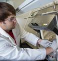 Georgia Tech researcher Andrew Brown places a finished hollow fiber metal-organic framework membrane module into a membrane testing apparatus to measure its gas separation properties.