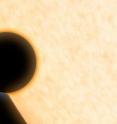 This is an artist's concept of the silhouette of the extrasolar planet HAT-P-11b as it passes its parent star. The planet was observed as it crossed in front of its star in order to learn more about its atmosphere.