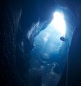 A scientist explores the remains of a supraglacial lake after it has drained.