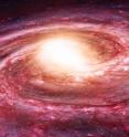 This is an artist's impression of the Milky Way. Its hot halo appears to be stripping away the star-forming atomic hydrogen from its companion dwarf spheroidal galaxies.