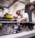 SLAC researchers Michael Litos, left, and Sebastien Corde use a laser table at the Facility for Advanced Accelerator Experimental Tests (FACET) to create a plasma used for accelerating electrons to high energies in a very short distance.