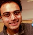 University of Utah electrical and computer engineering associate professor, Rajesh Menon, holds up a piece of silicon that has been etched with microscopic pillars and holes to create a polarized filter. He leads a team of researchers that have developed a new polarizer that can allow more light to pass through than conventional polarizers. This could lead to LCD displays for smartphones and tablets that last longer on a battery charge and cameras that can take better pictures at low light.