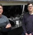 Andrew H. Marcus, left, and Mark C. Lonergan, both of the University of Oregon, stand by UO spectroscopy equipment that was adapted to study photon interactions in photocells that used lead-sulfide quantum dots as photoactive semiconductor material.