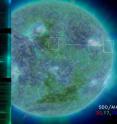 NASA's EUNIS sounding rocket examined light from the sun in the area shown by the white line (imposed over an image of the sun from NASA's Solar Dynamics Observatory) then separated the light into various wavelengths (as shown in the lined images - spectra - on the right and left) to identify the temperature of material observed on the sun. The spectra provided evidence to explain why the sun's atmosphere is so much hotter than its surface.