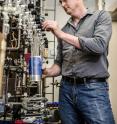 John Eiler works with a coiled trap on a glass vacuum line which is immersed in liquid nitrogen, one step in the cryogenic purification of gases used to standardize sample analyses.