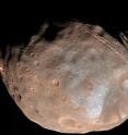 New modeling indicates that the grooves on Mars' moon Phobos could be produced by tidal forces -- the mutual gravitational pull of the planet and the moon. Initially, scientists had thought the grooves were created by the massive impact that made Stickney crater (lower right).