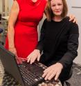 Professor Nadia Thalmann (left) standing beside Nadine (right), a social robot created in her image.