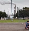 Chrisangel Nieto, age 3, rode his tricycle in front of the Valero refinery in Houston. This refinery processes almost 7 million tons of carbon per year, most of which will end up in the atmosphere as carbon dioxide.