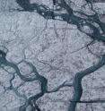 A 5- to 10-meter stream of meltwater flows on the Greenland icecap.