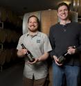IU biochemist Matthew Bochman, right, and Caleb Staton of Upland Brewing Co. in front of the barrels used to age sour beers. Bochman collaborated with Upland to develop an improved method to create sour beers.