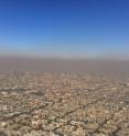 In the lower atmosphere, sunlight reacts with nitrogen oxides, methane and other volatile organic molecules to produce ozone. At this level of the atmosphere, ozone acts as a pollutant, rather than a protectant, as shown in this aerial photo of Mexico City. New research shows that if emission rates continue unchecked, some regions of the United States could experience between three and nine additional days per year of unhealthy ozone levels by 2050.