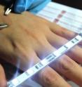 Highly conductive ultrathin film on skin between clips.