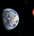 This artist's conception shows a red dwarf star orbited by a pair of habitable planets. Because red dwarf stars live so long, the probability of cosmic life grows over time. As a result, Earthly life might be considered "premature."