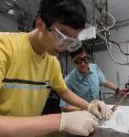 Rice University graduate student Xinwei Li, with physicist Junichiro Kono, prepares a sample for a cavity quantum electrodynamics experiment. They are part of a team probing the boundaries of light-matter interactions as they bridge traditional condensed matter physics and cavity-based quantum optics.