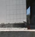 This rocking wall of a half-scale, three-story parking garage shakes dramatically during a recent simulated earthquake at UC San Diego's Englekirk Structural Engineering Center.