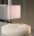 An oily substance called hexadecane beads up on this new type of membrane created by Purdue materials engineers to separate oil from water. If perfected, the new type of filter might be used for environmental cleanup, water purification and industrial applications. The researchers attached their material to a glass filter commonly used in laboratory research, and the modified filter, pictured here, works by attracting water while repelling oil, traits that are usually mutually exclusive.