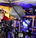 Ran Zhao and Yaroslav Dudin, graduate students in the Georgia Tech School of Physics, adjust optics in a system used to study quantum memory.