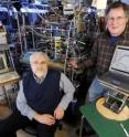Georgia Tech researchers pose in their laboratory with equipment used to study reaction rates of three key greenhouse gases.  Shown are J. Michael Nicovich and Paul Wine.