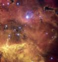 A colorful star-forming region is featured in this stunning new NASA/ESA Hubble Space Telescope image of NGC 2467. Looking like a roiling cauldron of some exotic cosmic brew, huge clouds of gas and dust are sprinkled with bright blue, hot young stars.

Strangely shaped dust clouds, resembling spilled liquids, are silhouetted against a colourful background of glowing. Like the familiar Orion Nebula, NGC 2467 is a huge cloud of gas — mostly hydrogen — that serves as an incubator for new stars.

This picture was created from images taken with the Wide Field Channel of the Advanced Camera for Surveys through three different filters (F550M, F660N and F658N, shown in blue, green and red). These filters were selected to let through different colours of red and yellow light arising from different elements in the gas. The total aggregate exposure time was about 2000 seconds and the field of view is about 3.5 arcminutes across. These data were taken in 2004.