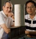 Scientists Pedro Alvarez (left) and Jaesang Lee stand behind a concrete cylinder and an I-beam, which are among the construction materials that manufacturers could potentially improve using certain nanomaterials.