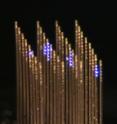 This is an optical image of the 3-D array with individual light ports illuminated. The array looks like a series of fine-toothed combs laid next to each other with their teeth pointing in the same direction.