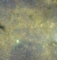 This image, taken with NASA's Spitzer infrared space telescope, shows the mysterious galactic cloud, seen as the black object on the left. The galactic center is the bright spot on the right.