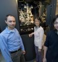 Purdue researchers Pavel Plevka (at left), Ju Sheng and Xinzheng Zhang, stand near the Titan electron microscope in Purdue's Wayne T. and Mary T. Hockmeyer Hall of Structural Biology. In research led by Michael G. Rossmann, Hanley Distinguished Professor of Biological Sciences, the team has discovered that rising temperature induces key changes in the dengue virus when it enters its human host, and the findings represent a new approach for designing vaccines against the aggressive mosquito-borne pathogen.